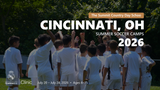 Group of young players in Real Madrid camp uniforms raising their hands in a team huddle during the Cincinnati, OH 2026 summer camp.
