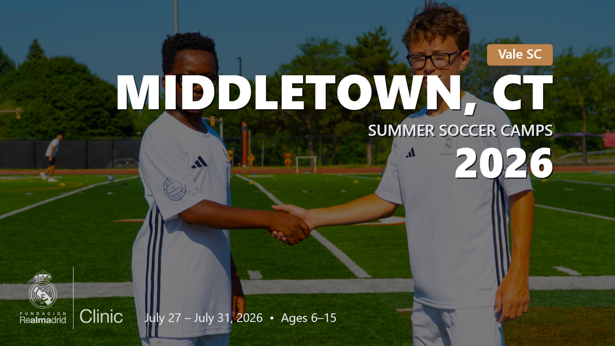 Two young players in Real Madrid camp uniforms shaking hands on a soccer field, promoting the Middletown, CT summer soccer camps for 2026.