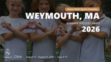 Group of young players in Real Madrid camp uniforms forming heart shapes with their hands during the Weymouth, MA 2026 summer soccer camp.