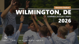 Coach and young players raising their hands together in a team huddle during the Wilmington, DE 2026 summer soccer camp.